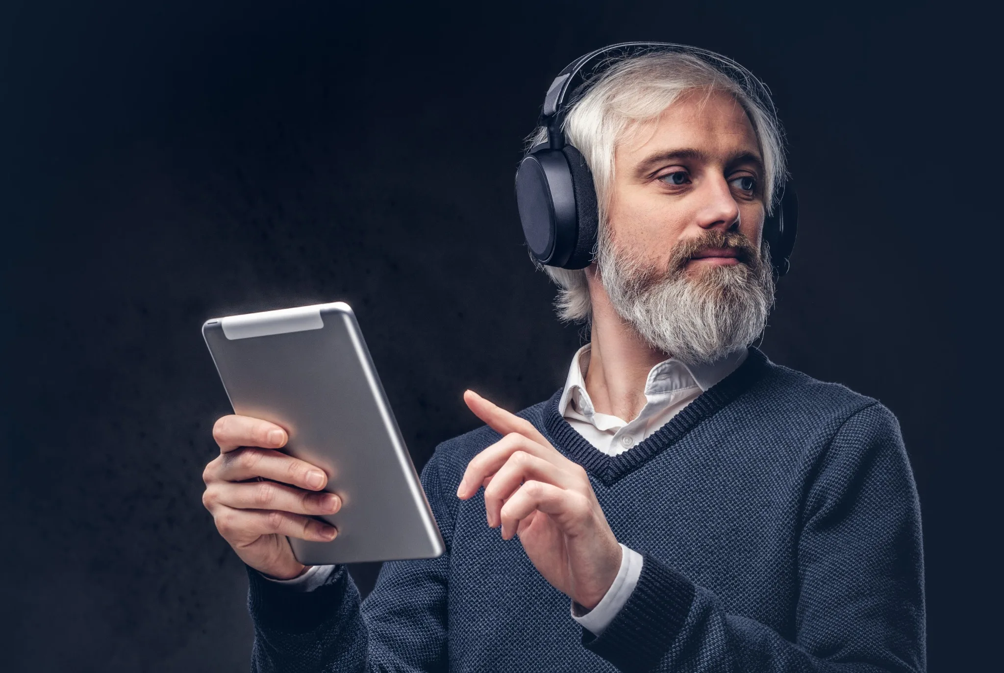 Audiobook listener using headphones and a tablet