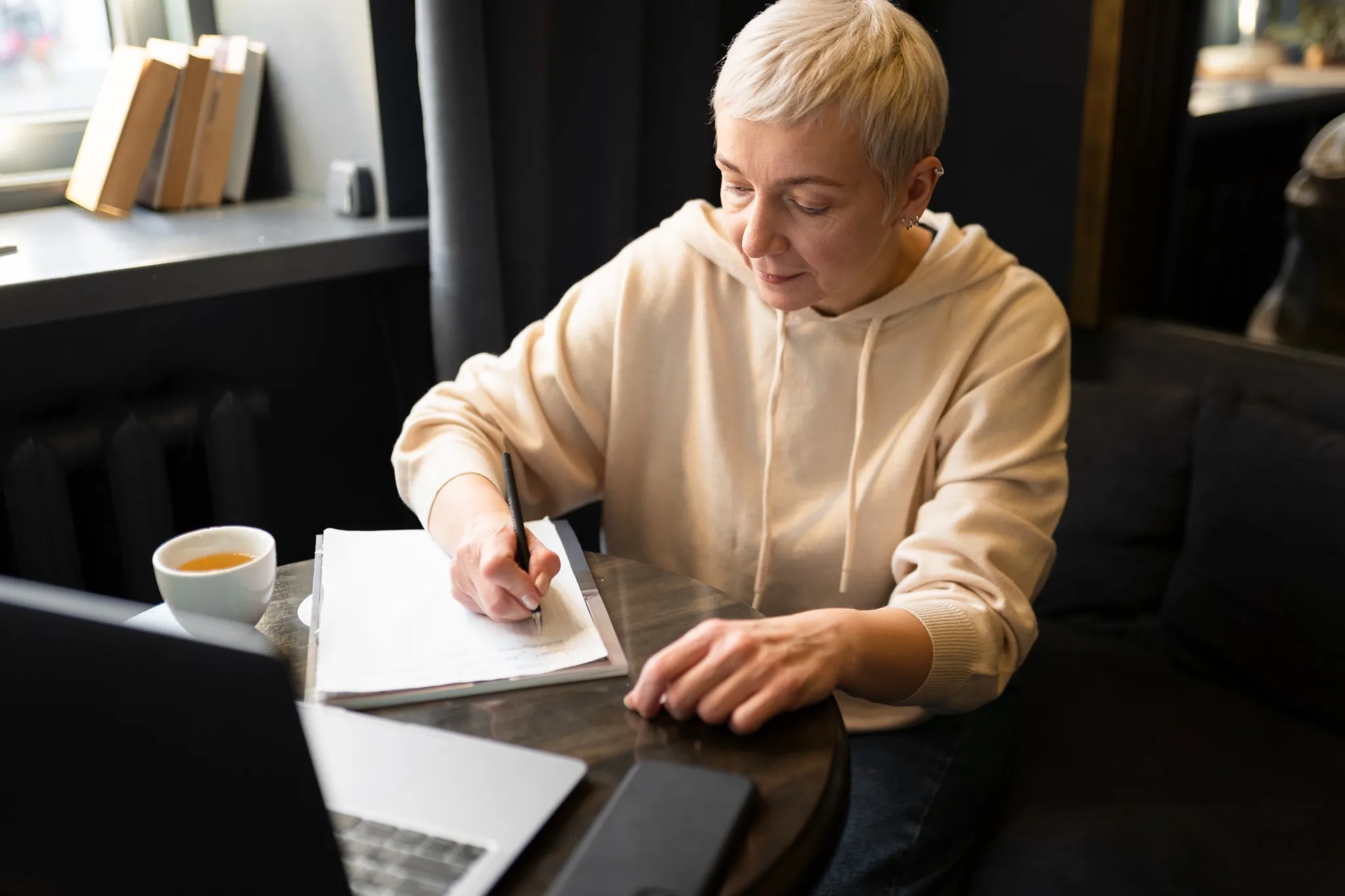 Author developing a manuscript while working on a laptop