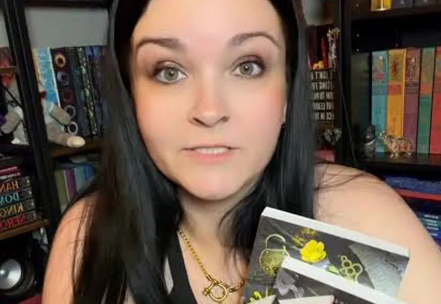 J.L. Beck holding a copy of Branded & Broken