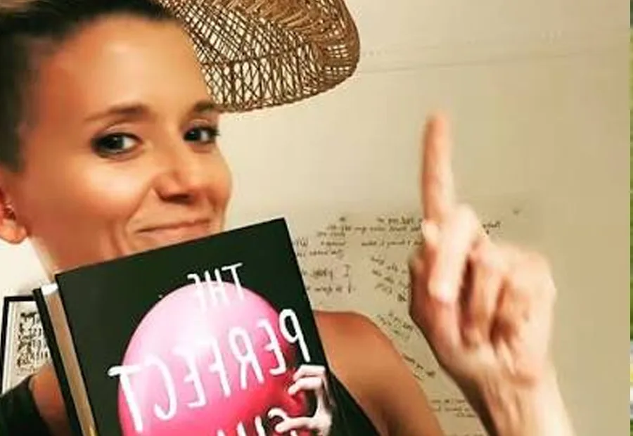 Lucinda Berry holding a copy of The Perfect Child